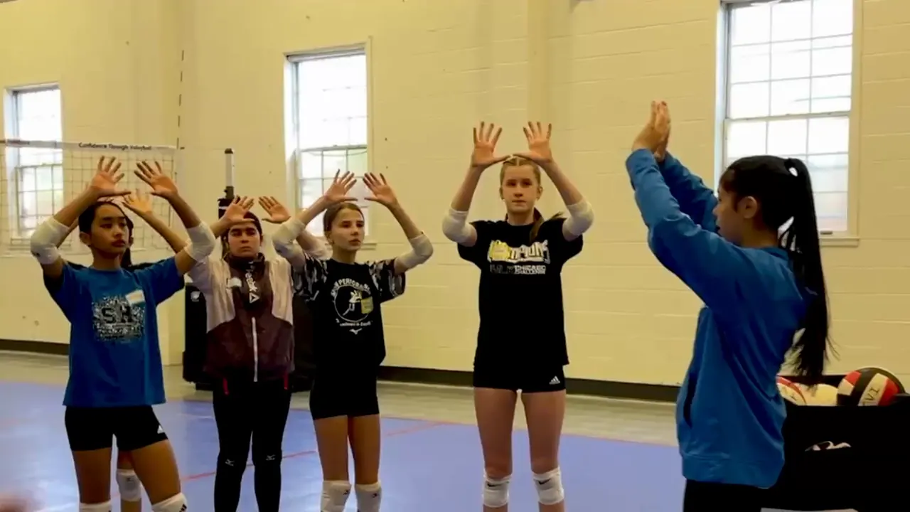 Young athletes holding their setting form at a free TVI clinic