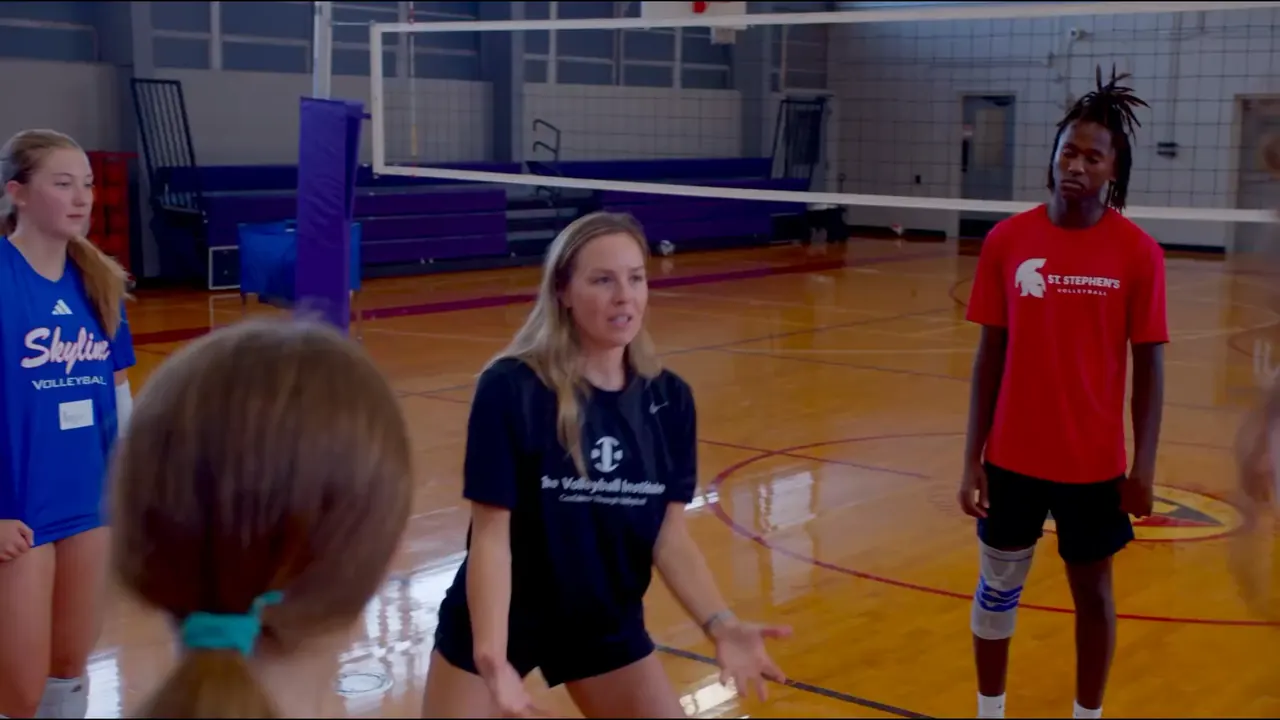 Caitlyn Donahue, a TVI Trainer, talking to a circle of athletes