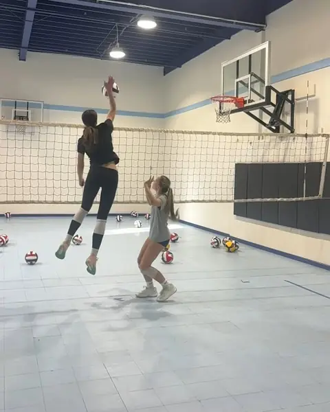 A middle blocker attacking a quick set