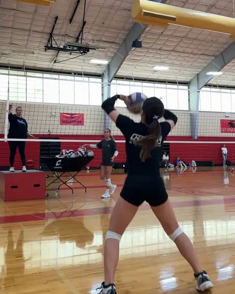 A defender digging a hard-driven ball with her hands
