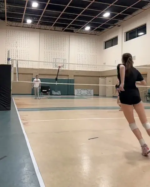 Noah Randall coaching a setter and an outside hitter