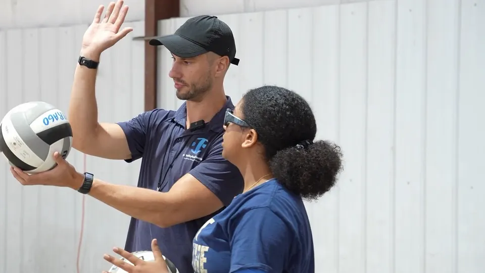 Alex Hurlburt, TVI's Founder, teaching one athlete a serving toss