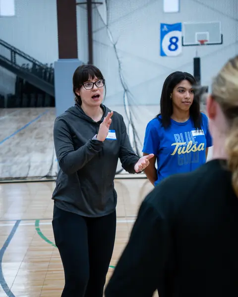 A TVI Trainer explaining a skill to athletes during a clinic