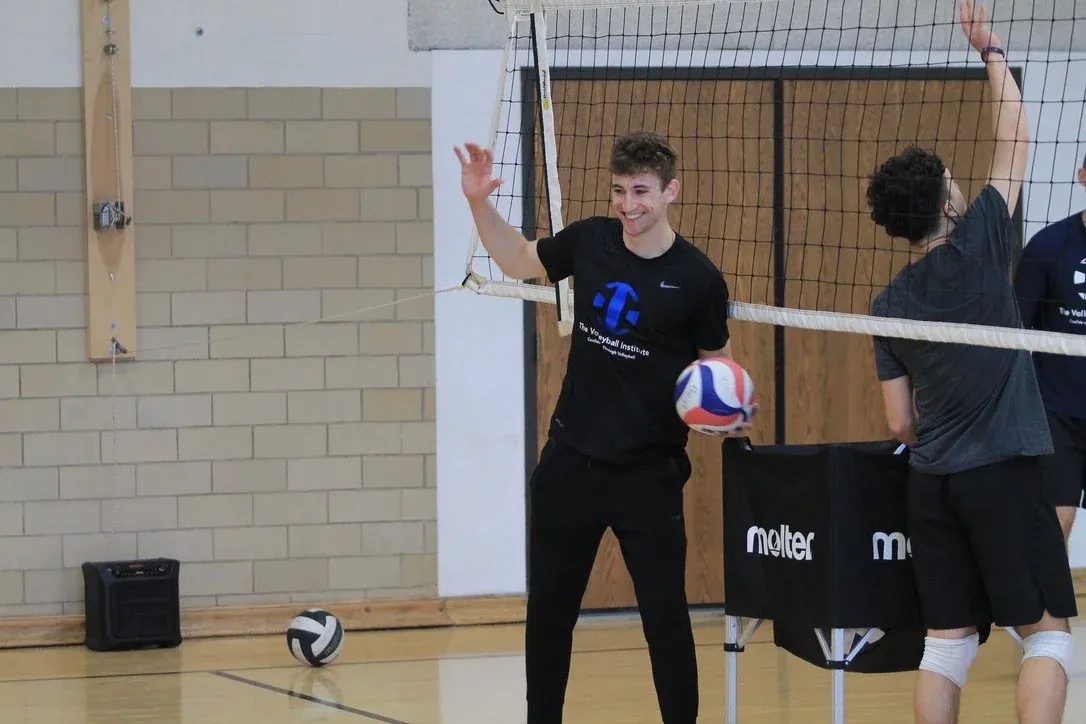 Noah Randall, a TVI Trainer, coaching at the net during a session